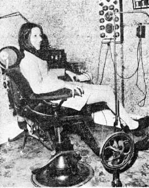Library assistant Carole Wilkinson tries out the 1910 dentist's chair.
