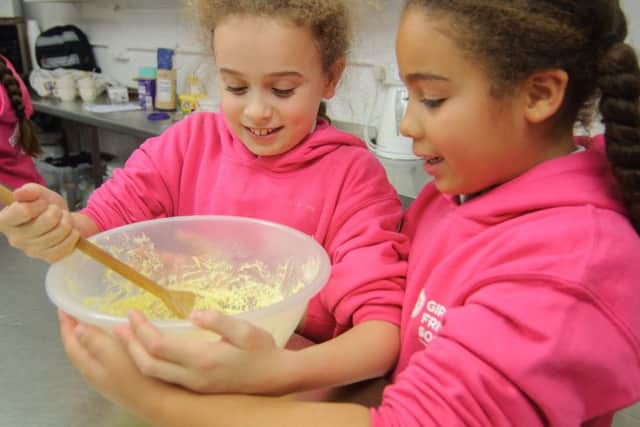 Members of the Girls Friendly Society try their hand at baking.