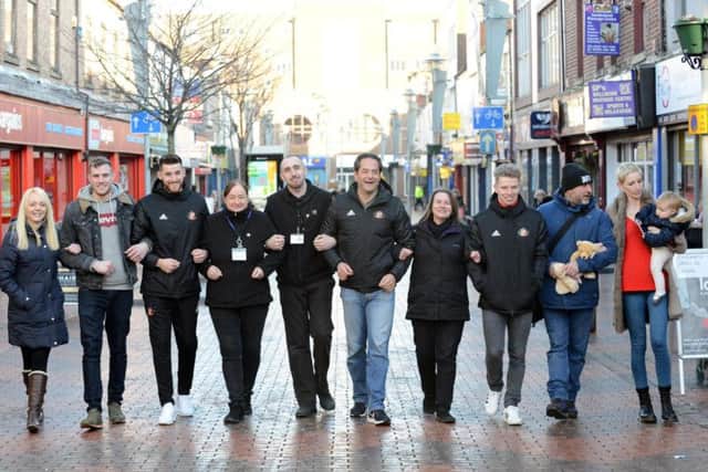 Sunderland AFC's executive director Charlie Methven and players Jack Baldwin and Grant Leadbitter meet traders from the city centre's Blandford Street.