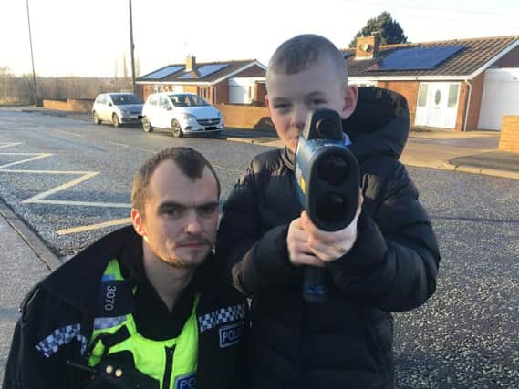 PC Peter Baker shows one of the pupils how to use the speed gun.