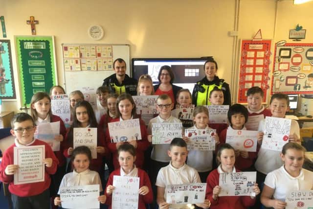 Children from English Martyrs' RC Primary School with, from left, PC Peter Baker, Coun Alex Samuels and PC Louise Turnbull.
