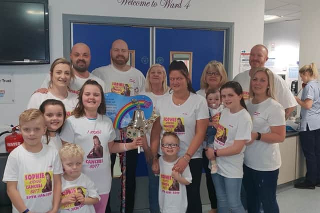 Sophie Laidler surrounded by her family rings the bell at the RVI following the completion of her chemotherapy treatment.