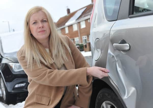 Laura Marriner with the damage to her Nissan Note, after a car hit her then drove off.