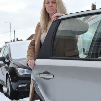 Laura Marriner with the damage to her Nissan Note, after a car hit her then drove off.