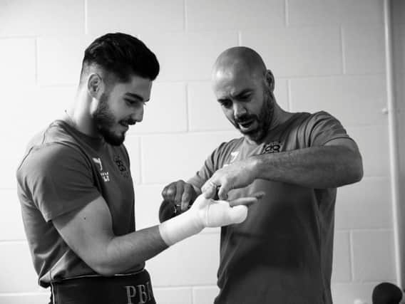 Josh Kelly (left) with trainer Adam Booth (right). Picture via Matchroom Boxing.