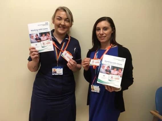 Faye Wright, Ward Manager at South Tyneside District Hospital, right, and Jennifer Musgrave, Patient Experience Facilitator with South Tyneside and City Hospitals Sunderland NHS Foundation Trusts, holding the Carer Passport badge and folder.