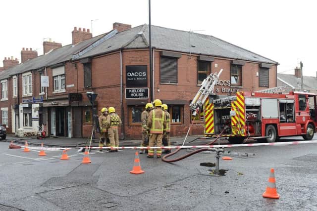 The road is closed off while firefighters tackle the blaze at DACCS salon.