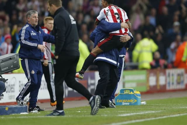 Patrick van Aanholt celebrates a Sunderland goal with Sam Allardyce.