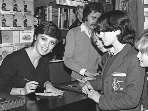 Pop star Sheen Easton signs autographs for young customers at Sunderland's former HMV store in 1981.