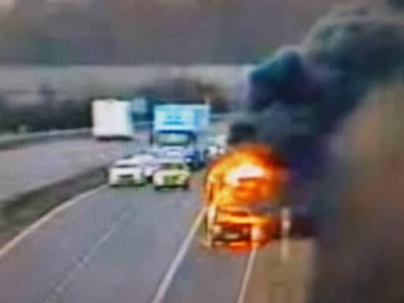 A car on fire on the side of the A1. Pic courtesy of Highways England.