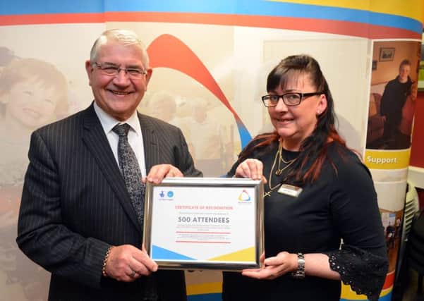 Durham Police Crime and Victims' Commissioner Ron Hogg presents a certificate marking the 500th attendee milestone to  community job clubs project co-ordinator Lisa Taylor.