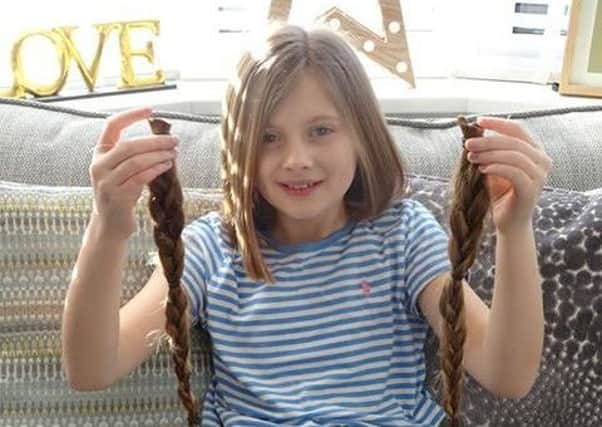 Charlotte Hughes, nine, with her hair that will be used to make wigs for poorly youngsters.