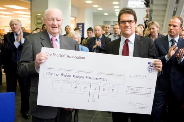 Sir Bobby with Fabio Capello, on behalf of the Football Association, as it donated £75,000 on the day the Sir Bobby Robson Centre opened.
