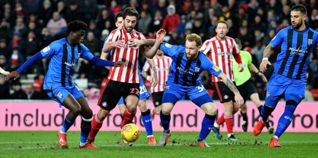 Sunderland forward Will Grigg is surrounded by Gillingham player on Tuesday night.