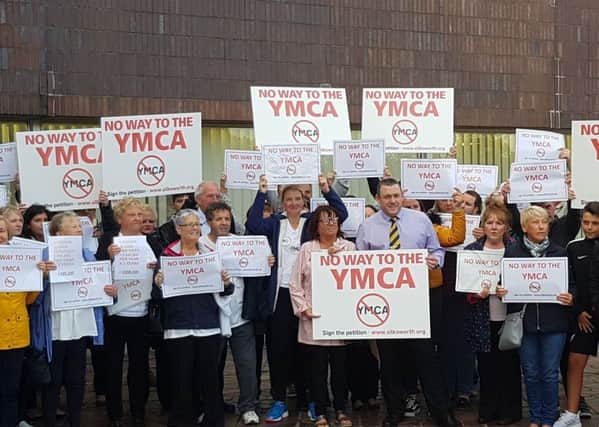 Campaigners protest against the YMCA plan.