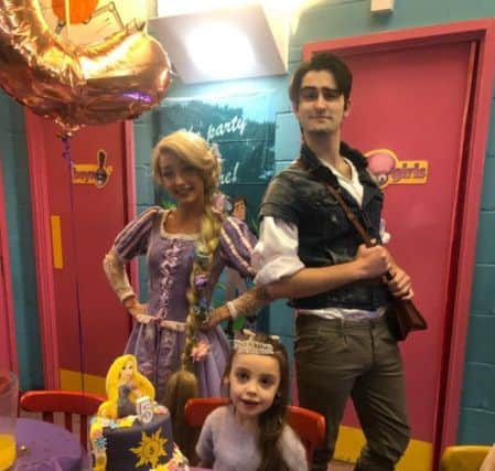 Rapunzel and Flynn Rider help Chanel Murrish celebrate her fifth birthday.