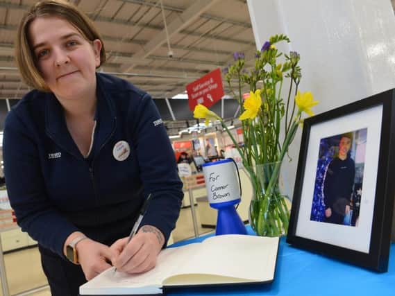 Laura Hunns signs a book of condolence to Connor Brown at Tesco in Roker.