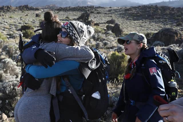 Little Mix singer Jade Thirlwall hugs a fellow member of Team Kilimanjaro during their climb for Comic Relief. Pic: Chris Jackson/Getty Images.