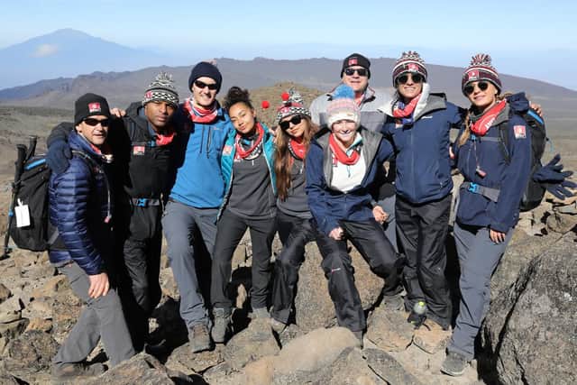 Members of Team Kilimanjaro pose for a picture as they take a breather during their climb for Comic Relief. Pic: Chris Jackson/Getty Images.