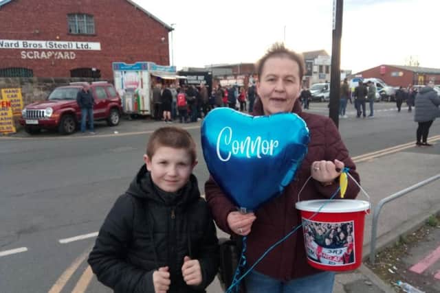 Connor's Crew collectors held blue heart-shaped balloons decorated with his name as they raised funds.