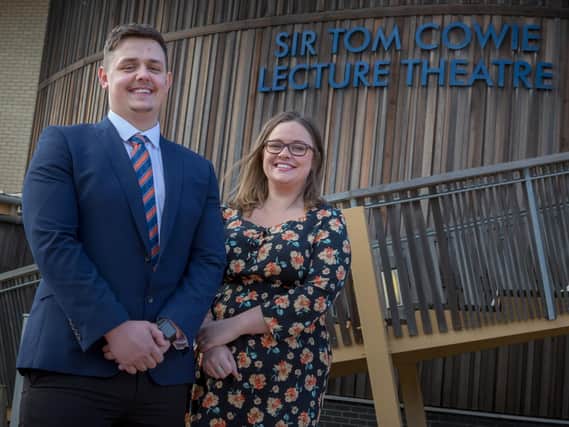 Business and Financial Management student Jesse Thompson with Primary Education student Vicky Graham outside Sunderland University's Sir Tom Cowie Lecture Theatre.