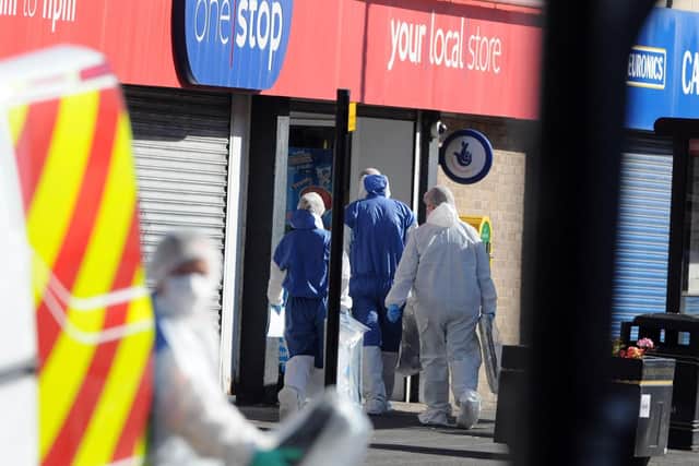 Police officers at the One Stop shop where Joan Hoggett was stabbed to death.