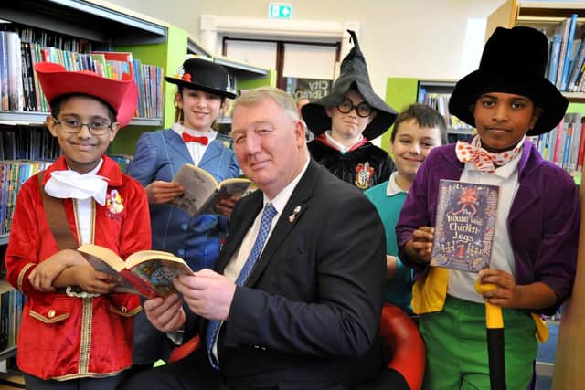 Coun John Kelly and youngsters from Valley Road Academy enjoy a trip to the library.