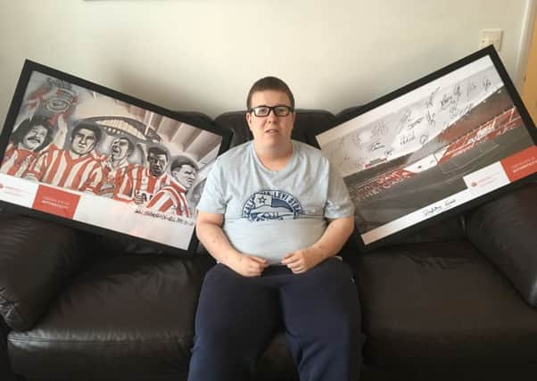 Blind phtotographer, Alex Ditch, with the signed Sunderland AFC photos he is raffling for charity.