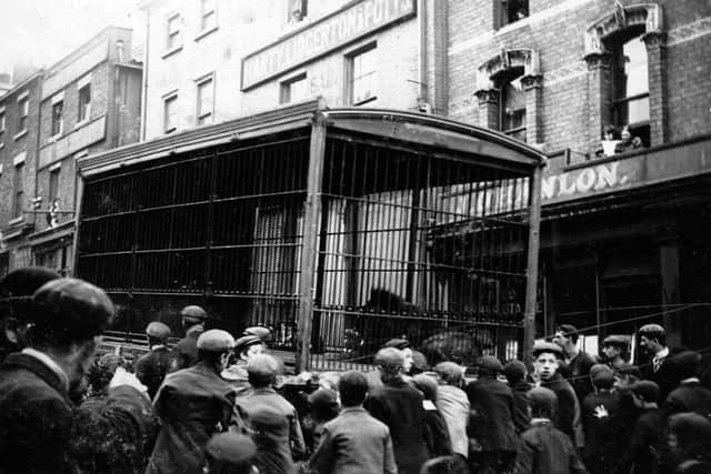 A scene which is quite rightly now banned, as the crowd surround one of the circus lions in a cage.