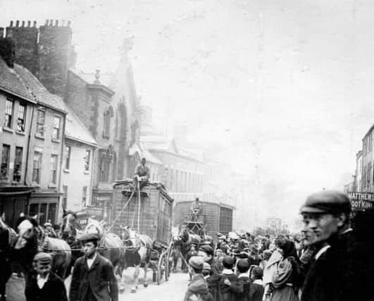 Huge crowds watched the circus as it passed through High Street East.