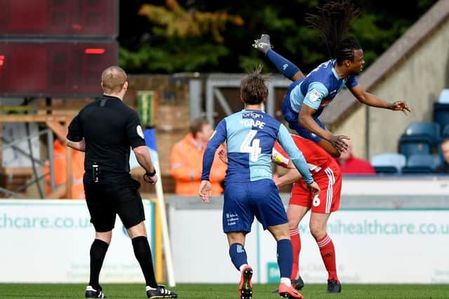 A Wycombe player takes a tumble.