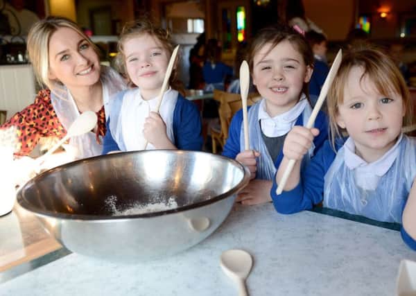 Teacher Jenny Knowlson looks on as Eldon Grove Primary School pupils (left to right) Clara Wright, Elise Hall and Lynda Russell make their pizza.