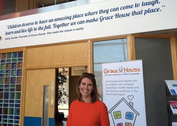 Sky News presenter Jayne Secker at Grace House in front of the tribute to her mum Kathy.