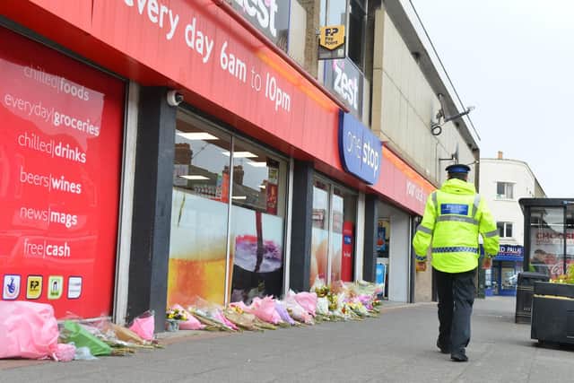 Scores of flowers were left outside the shop where Joan Hoggett was attacked as she worked.