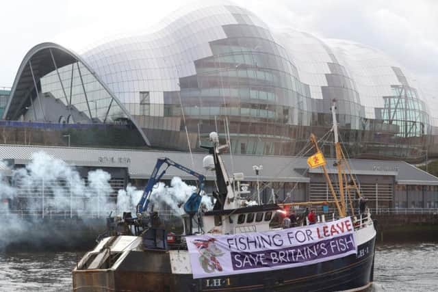 A boat taking part in last April's protest heads up the River Tyne. Photo by PA.