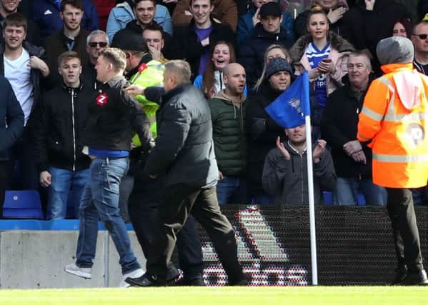 The fan who attacked Aston Villa's Jack Grealish is escorted off the pitch during the Sky Bet Championship match at St Andrew's Trillion Trophy Stadium, Birmingham. PRESS ASSOCIATION Photo. Picture date: Sunday March 10, 2019. See PA story SOCCER Birmingham. Photo credit should read: Nick Potts/PA Wire. RESTRICTIONS: EDITORIAL USE ONLY No use with unauthorised audio, video, data, fixture lists, club/league logos or "live" services. Online in-match use limited to 120 images, no video emulation. No use in betting, games or single club/league/player publications.
