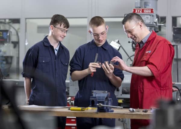 (from left) apprentices Liam Rowden and Matthew Reilly with Gateshead College tutor Anthony Jeff