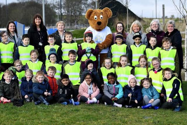 Benedict Bear joins pupils and staff from St Patrick's Primary School as they start to plant trees in the grounds of St Benedict's Hospice.