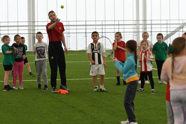 SAFC u23 footballer Alex Storey with pupils at the Beacon of Light with pupils from West Rainton Primary School.