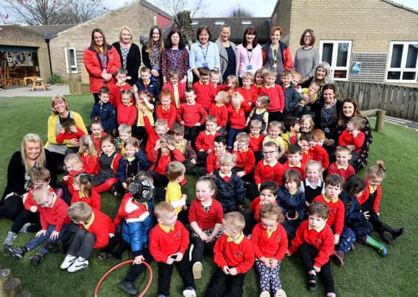 Julie Heron (rear centre) Headteacher of Oxclose Community Nursery School with staff and pupils. Picture by FRANK REID