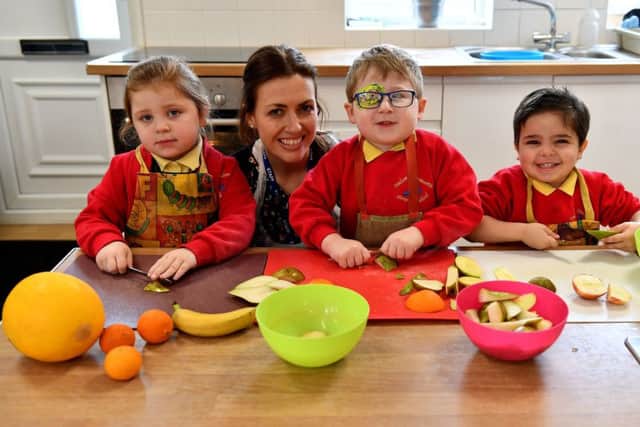 Oxclose Community Nursery School early years practitioner Lorraine Brown with pupils (left to right) Darcey Hogg, James Pickbourne and Mazen Khattab. Picture by FRANK REID
