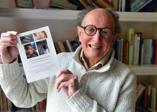 Retired surgeon Ian Rogers with his book.