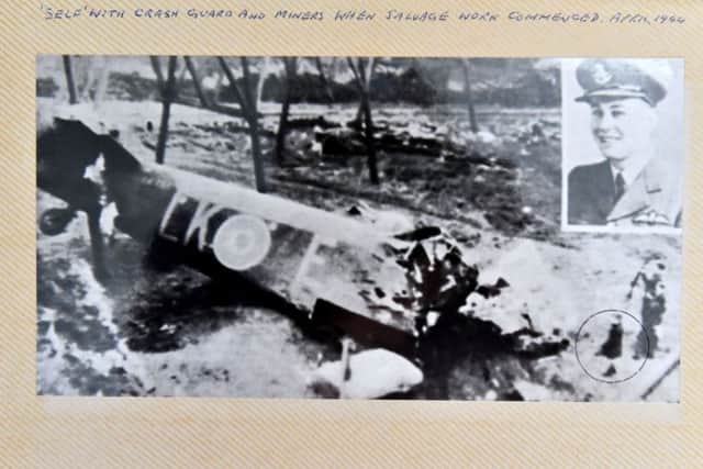 A photograph of Alan Mitcheson (circled) looking at the crashed Halifax bomber.