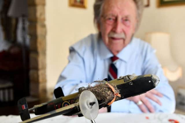 Alan Mitcheson with a model of the Halifax bomber he made.