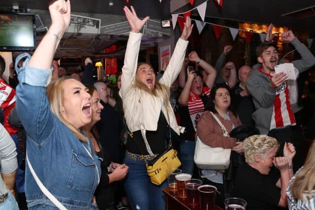 Sunderland fans celebrate Sunderland's first goal at TTonic bar in Sunderland.
