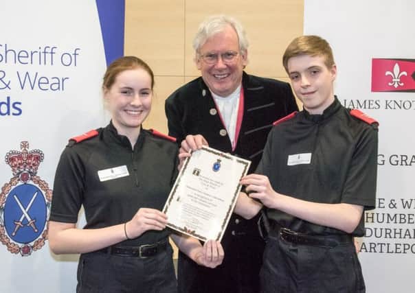 Volunteer police cadets Anya Coleman and Damon Gilmore, both 15, receive an award from High Sheriff of Tyne & Wear Paul Callaghan.