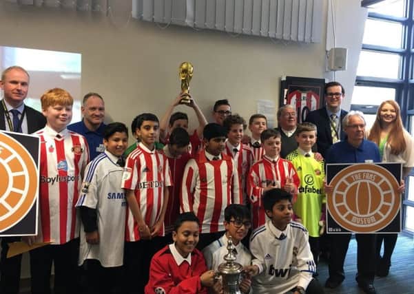 Former Sunderland captain Bobby Kerr, back row, second right from right, meets with pupils at St Aidan's Catholic Academy as they held their Great Exhibition.