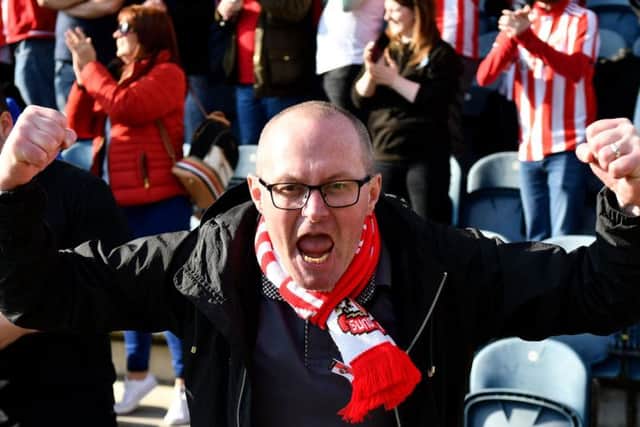 A Sunderland supporter celebrates the three points at Spotland.