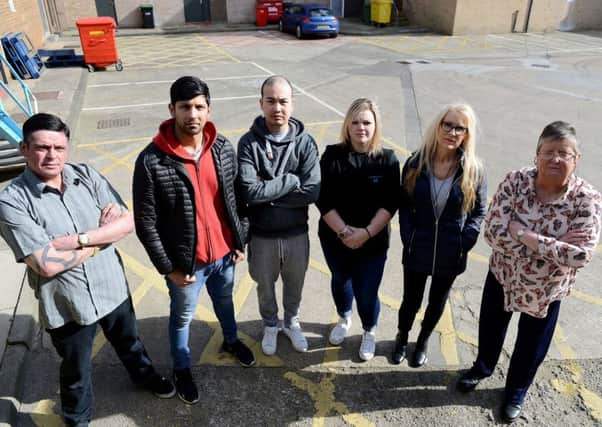 Traders (Left to right) Robbie Bleasdale, Umar Aktar, Nguyen Anh, Umar Akhtar, Stacey Sayers, Julie Tilley and Shelia Fusco standing at a service area, Castle Dene Shopping Centre Peterlee. Picture by FRANK REID