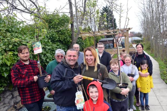 Former Blue Peter gardener Chris Collins and founder Jennie Franks (middle) with the volunteers.